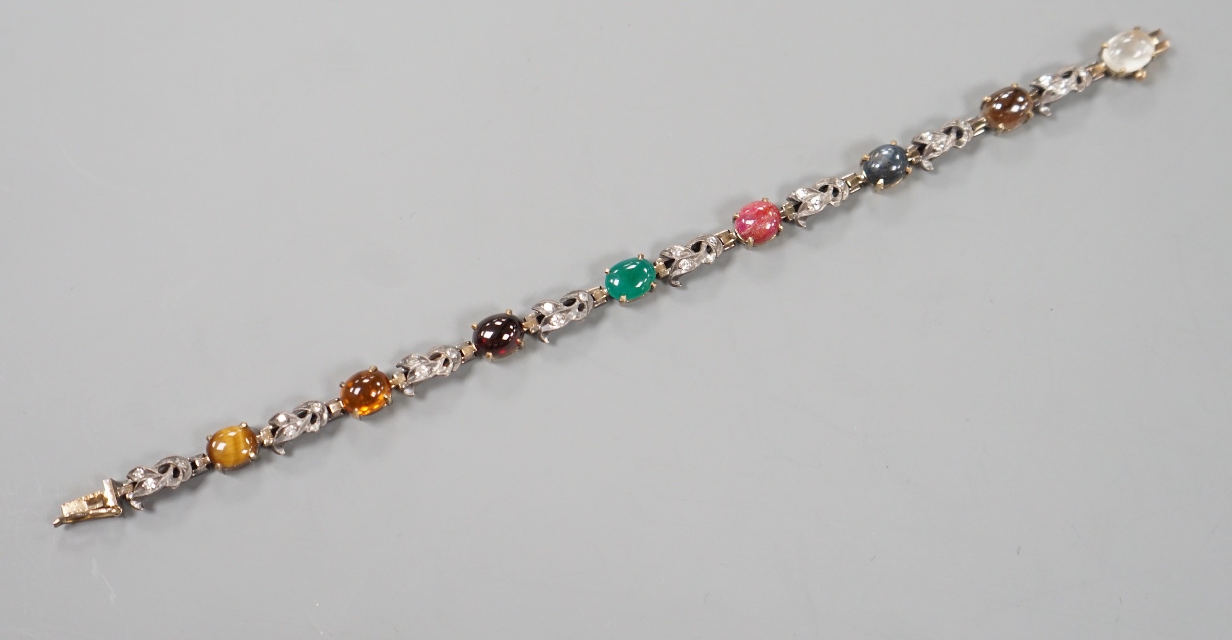 A yellow and white metal, multi cabochon gem and rose cut diamond set bracelet, 16.7cm, gross weight 11.9 grams.